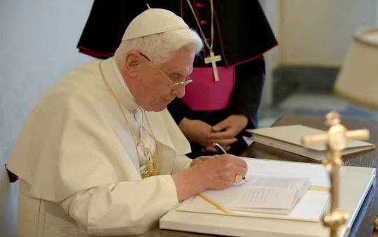 Pope Benedict XVI writing at his desk